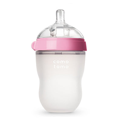 Baby bottle with pink cap and white body on a white background