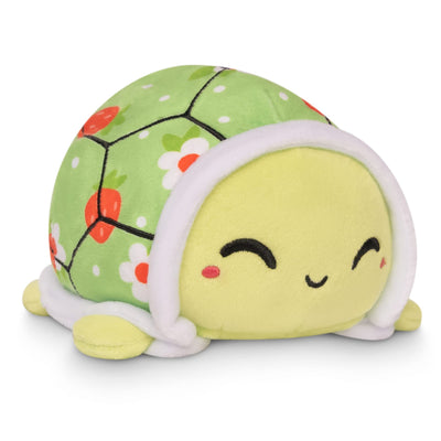Plush turtle toy with a green shell and yellow body on a white background