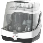 Baby bottle sterilizer with clear lid showing bottles inside, branded 'babybrezza'.