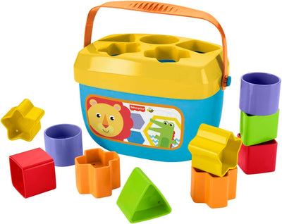 Colorful toy set with shape sorter and cups on a white background
