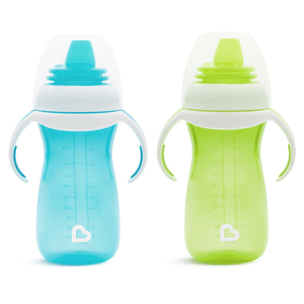 Two baby sippy cups, one blue and one green, on a white background.