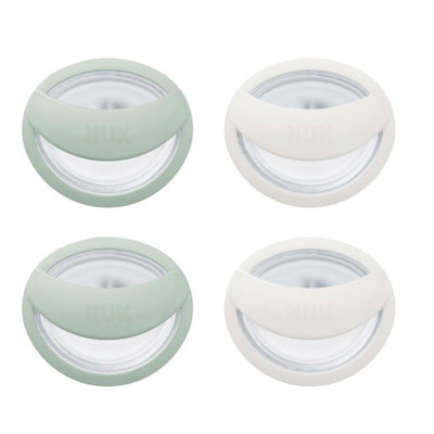 Four round containers with green and white lids on a white background