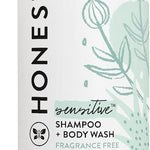 Honest sensitive shampoo and body wash bottle with green and white design.