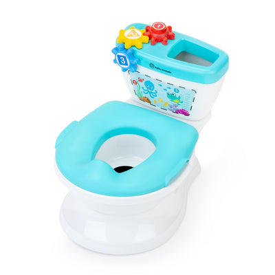 Children's toy toilet with colorful buttons and a seat on a white background