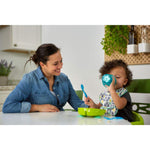 Woman and child at a kitchen table with eating utensils
