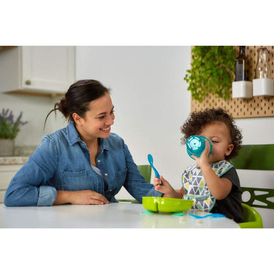 Woman and child at a kitchen table with eating utensils