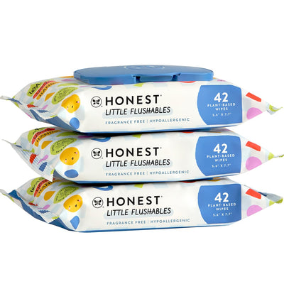 Three packages of 'Honest' Little Flushables wipes on a white background