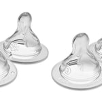 Four clear baby bottle nipples on a white background