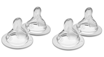 Four clear baby bottle nipples on a white background