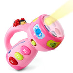 Pink toy flashlight with colorful buttons and cartoon characters on a white background