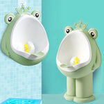 Two green frog-shaped urinals on a blue tiled wall.
