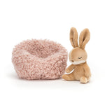 Small plush chair with a fluffy texture next to a plush rabbit toy on a white background