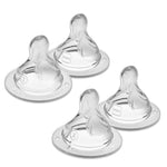 Four clear baby bottle nipples on a white background