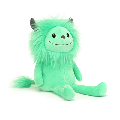 Green plush toy with black horns on a white background