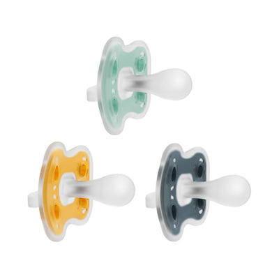 Three colorful pacifiers on a white background