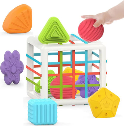 Colorful geometric shape sorter toy with shapes around it on a white background