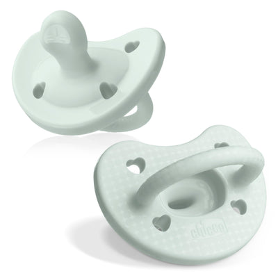 Two light green baby pacifiers on a white background