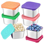Set of stainless steel food storage containers with colorful lids, filled with nuts and berries.