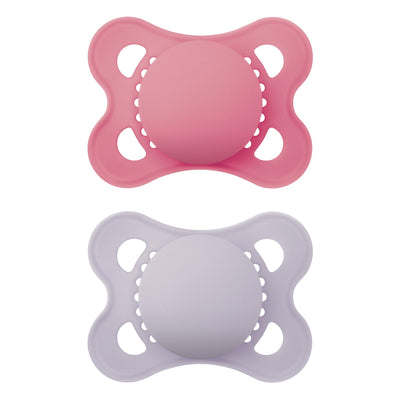 Two pink and purple baby pacifiers on a white background