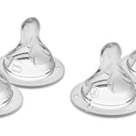 Four clear baby bottle nipples on a white background