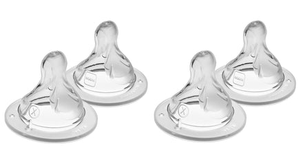 Four clear baby bottle nipples on a white background