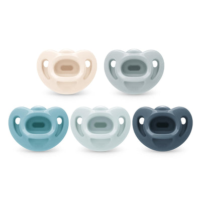 Set of five baby pacifiers in different colors on a white background