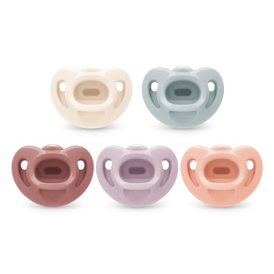 Set of five colorful baby pacifiers on a white background