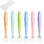 Set of six colorful baby spoons with heart designs on a white background