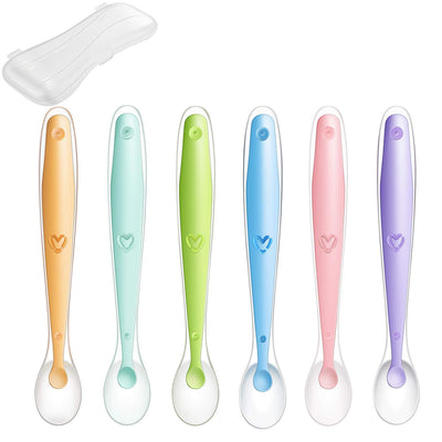 Set of six colorful baby spoons with heart designs on a white background