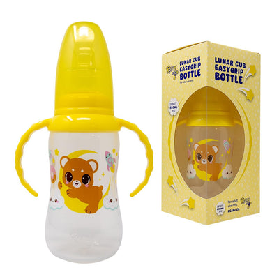 Yellow and white baby bottle with bear design and packaging on a white background
