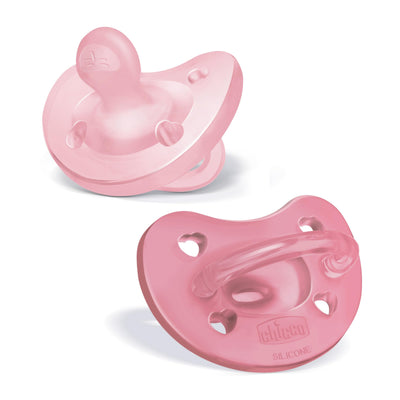 Two pink baby pacifiers on a white background