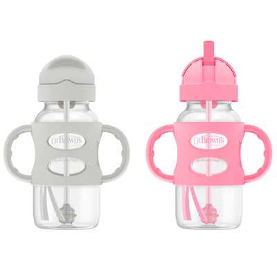 Two baby bottles with handles and pink and gray lids on a white background