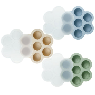 Set of five silicone ice cube trays in different colors on a white background
