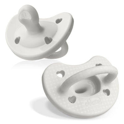 Two white baby pacifiers on a white background
