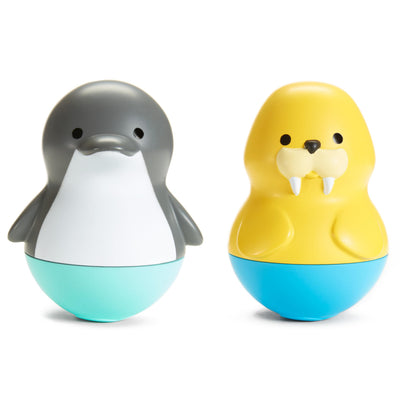Two toy figures, one gray and white resembling a penguin, and the other yellow with a blue base, on a white background.