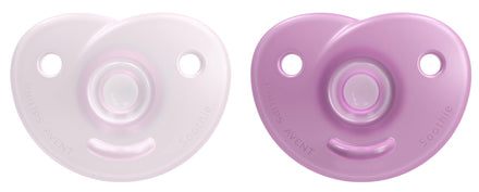 Two baby pacifiers, one white and one purple, on a white background.