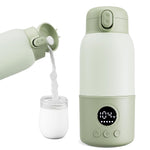 Green electric milk heater pouring milk into a glass jar on a white background