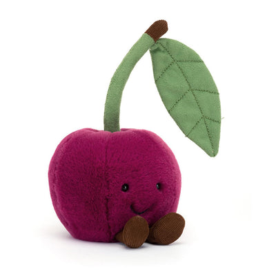 Plush toy cherry with a leaf on a white background