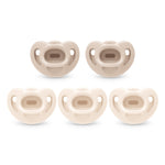 Set of five beige baby pacifiers on a white background