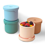 Set of colorful food containers with lids on a white background