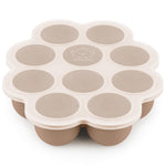 Beige silicone mold with circular compartments on a white background