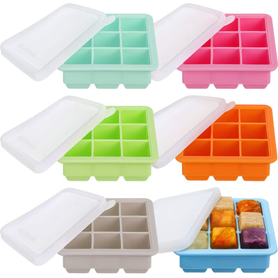 Set of colorful silicone ice cube trays with lids on a white background