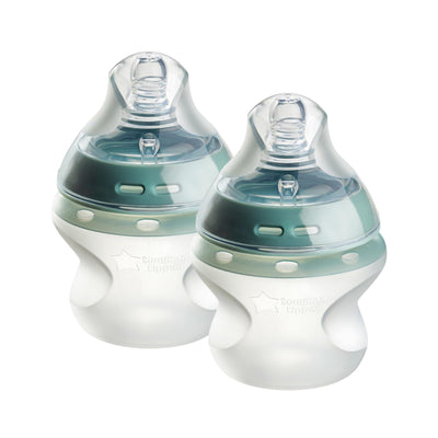 Two baby bottles with green and clear design on a white background