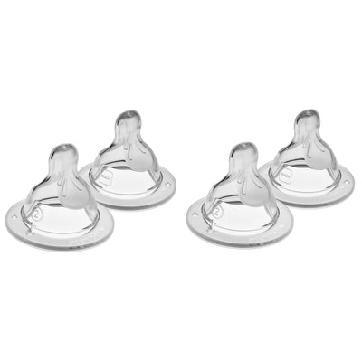 Four clear baby bottle nipples on a white background