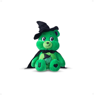 Green plush toy with witch hat and cape on a white background