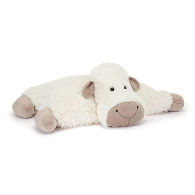 Plush toy cow lying on a white background