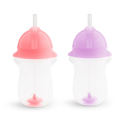 Two sippy cups with pink and purple lids on a white background