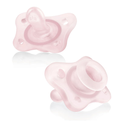 Two pink baby pacifiers on a white background
