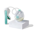 Breast pump with a clear container on a white background