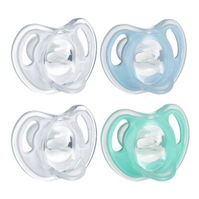 Four baby pacifiers in clear, light blue, and mint green on a white background